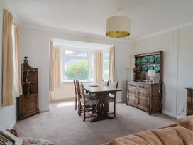 A dining room with a table and chairs at Gosling Way Lyme Regis