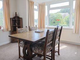 A dining room with a table and chairs at Gosling Way in Lyme Regis