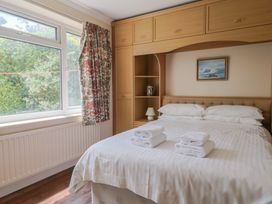 A bedroom with a bed and a window at Gosling Way in Lyme Regis