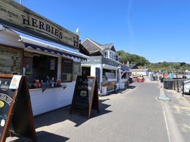 A row of food stalls along the beach at Gosling Way Lyme Regis