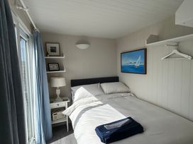 A bedroom with a bed and side table at 8 Bowling Green Chalets Lyme Regis