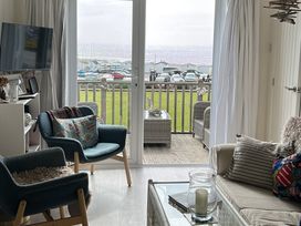 A living room with a view of the coastline at 8 Bowling Green Chalets in Lyme Regis