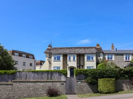 A house with a gate and hedge at Ancient Lights in Lyme Regis