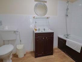 A bathroom with a toilet, sink, shower, and bathtub at The Orchard Country House Rousdon