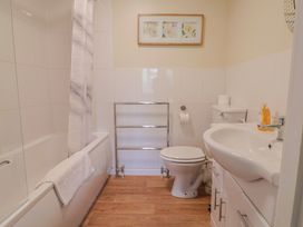 A bathroom with a bathtub toilet and sink at The Orchard Country House Rousdon