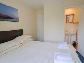 A bedroom with a bed and an ensuite bathroom at The Orchard Country House Rousdon