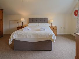 A bedroom with a bed and two lamps at The Orchard Country House in Rousdon