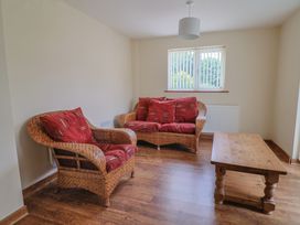 A living room with a sofa and coffee table at The Orchard Country House Rousdon