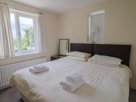 A bedroom with a double bed and a window at The Orchard Country House Rousdon