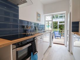 A kitchen with a stove and dishwasher at High Trees in Lyme Regis