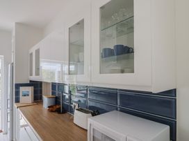 A kitchen with cabinets and appliances at High Trees in Lyme Regis