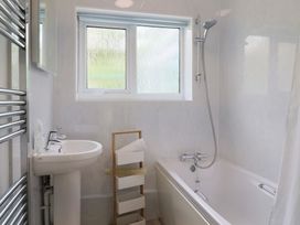 A bathroom with a sink and bathtub at High Trees in Lyme Regis