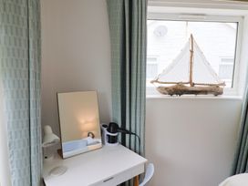 A bedroom with a desk and a mirror at High Trees in Lyme Regis