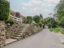 Steps leading up to a property with a stone wall at High Trees in Lyme Regis