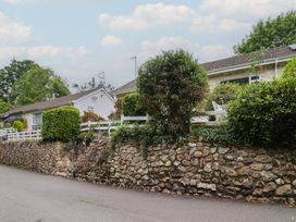 A house with a garden and a stone wall at High Trees in Lyme Regis