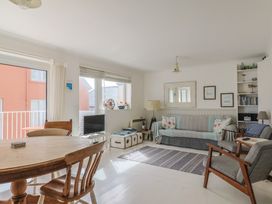A living room with a dining table and sofa at 1 Bay View Court in Lyme Regis