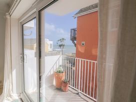 A balcony view with a planter and sliding glass door at 1 Bay View Court Lyme Regis