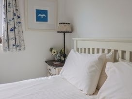 A bedroom with a bed and lamp at 1 Bay View Court in Lyme Regis