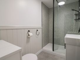 A bathroom with a shower and sink at 1 Bay View Court in Lyme Regis
