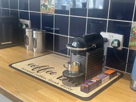 A coffee machine on a countertop at High Bullen Cottage in Morcombelake