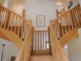 A staircase with railings leading to an upper floor at Yard Cottage in Rousdon
