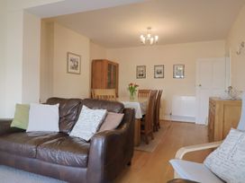 A dining room with a table and chairs at Greystones Lyme Regis