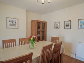 A dining room with a table and chairs at Greystones Lyme Regis