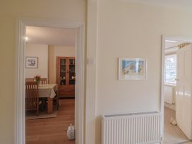 A hallway with a view into a dining room at Greystones Lyme Regis