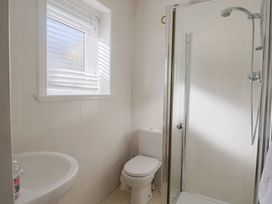 A bathroom with a sink toilet and shower at Greystones Lyme Regis