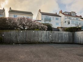 A view of houses and flowering bush at Greystones Lyme Regis