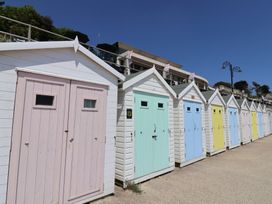 A row of colorful beach huts at Greystones in Lyme Regis