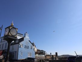 A building with a clock near Rock Point in Lyme Regis