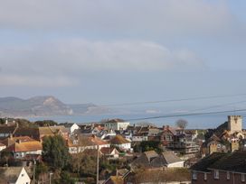A view of houses and hills overlooking the sea at Greystones Lyme Regis