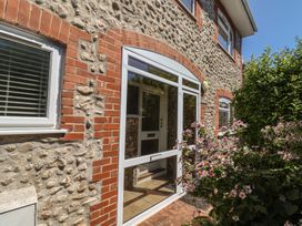 An entrance with a glass door and flowers at Greystones in Lyme Regis