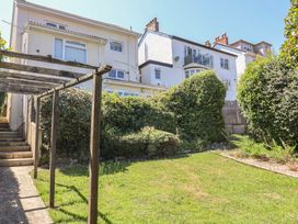 A garden with steps and a pergola at Greystones Lyme Regis