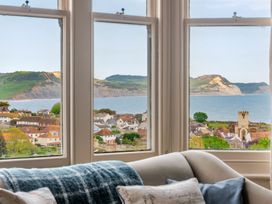 A living room with a view of the coastline and town at 2 Hadleigh Villas Lyme Regis