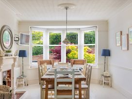 A dining room with a wooden table and chairs at 2 Hadleigh Villas Lyme Regis