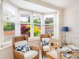 A dining room with chairs and a table at 2 Hadleigh Villas in Lyme Regis