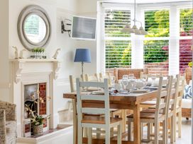 A dining room with a table set for meals at 2 Hadleigh Villas Lyme Regis