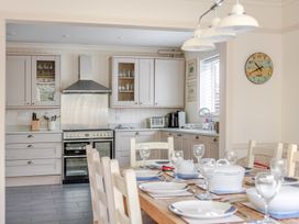 A kitchen with a dining table set for meals at 2 Hadleigh Villas in Lyme Regis