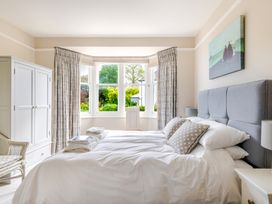 A bedroom with a bed and wardrobe at 2 Hadleigh Villas Lyme Regis