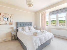 A bedroom with a bed and bedside lamps at 2 Hadleigh Villas in Lyme Regis