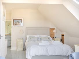 A bedroom with a bed and a lamp at 2 Hadleigh Villas Lyme Regis