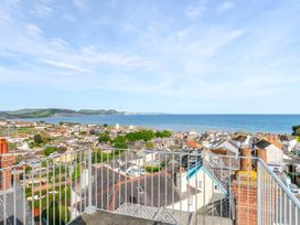 A view of rooftops and ocean from an elevated position at 2 Hadleigh Villas in Lyme Regis