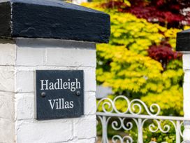 A sign with Hadleigh Villas at an entrance with plants at 2 Hadleigh Villas Lyme Regis