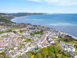 An aerial view of a coastal town with beach and ocean at 2 Hadleigh Villas Lyme Regis