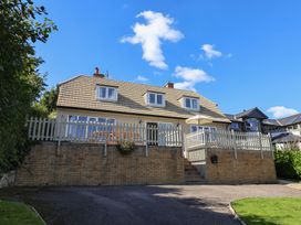 A house with a balcony and fence at Westhaven in Lyme Regis