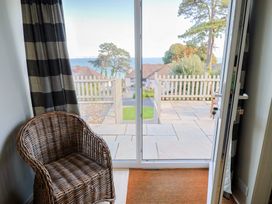An indoor area with a chair and a view of the sea at Westhaven in Lyme Regis
