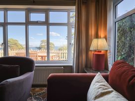 A living room with a view and a lamp at Westhaven in Lyme Regis