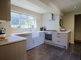 A kitchen featuring a sink, stove, and cabinets at Westhaven in Lyme Regis